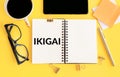 Exploring the Japanese Concept of Ikigai Through Notebook and Accessories on a Yellow Background