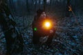 Exploring the nighttime forest, a man shines his flashlight ahead. Royalty Free Stock Photo