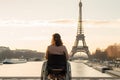 Exploring Paris as a wheelchair user. Back of disabled woman looking on Eiffel tower. Generative AI