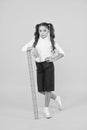 Exploring stem. Education and school concept. Sizing and measuring. Pupil cute girl with big ruler. Geometry school