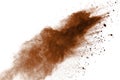 Explosion of brown powder on black background