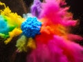 Explosion of colored powder on black background. Abstract colored background. Yellow, pink, purple, red, orange, green Royalty Free Stock Photo