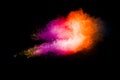 Explosion of colorful pigment powder on black background.Vibrant color dust particles textured background Royalty Free Stock Photo