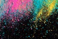 An explosion of colorful pigment powder on black background. Vibrant color dust particles textured background