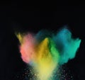 Explosion of colorful powder isolated on dark black background. Holi paint color dust explode in freeze motion. Generative AI Royalty Free Stock Photo