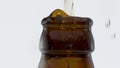 Explosion lager beer bottle in super slow motion close up. Wheat drink splashing