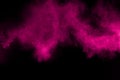 Explosion of pink color powder on black background. Splash of color powder dust on dark background Royalty Free Stock Photo