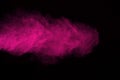 The explosion of pink powder. Freeze motion of color powder exploding isolate on black background.