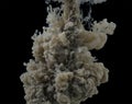 explosion in water of dark gray paint, dissolves in clouds in water. Black background Royalty Free Stock Photo