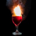 The explosion of wine in a glass, a lot of splashes and fragments, the harm of alcohol Royalty Free Stock Photo