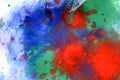 Explosive emotional drops of red, green, blue on white paper