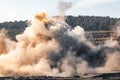 Explosive works on open pit coal mine industry. Dust and puffs of smoke in sky, blasted soil