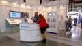 Expo and convention center. Booth of company participating in a technology exhibition, equipped with modern monitors, displays.