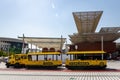 Expo 2020 Dubai - Expo Explorer yellow compressed air train parked in front of Mission Possible - The Opportunity Pavilion.