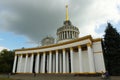 Expocenter or exhibition hall in Kyiv, white soviet building with many columns, example of Sta