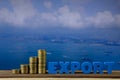 EXPORT text and stack of coin on wood table over seascape and ca Royalty Free Stock Photo