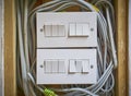 Modern wall light switches with all their wires exposed