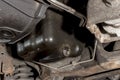 The exposed oil drain plug underneath the chassis of an SUV Royalty Free Stock Photo