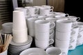 Exposed on stacks of white clean ceramic cups and saucers. Dishes in the restaurant for tea and coffee Royalty Free Stock Photo