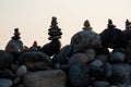 Exposed stones one on the other silhouettes on the beach