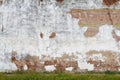 Exposed white stucco concrete red brick garden wall grass verge afternoon