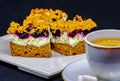 Exposition of cake with Aronia white cream on white plate near cup of coffee with sugar isolated on black background Royalty Free Stock Photo