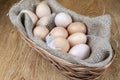 Exposition of fresh eggs, easter, eggs in basket for egg on wooden table. Royalty Free Stock Photo