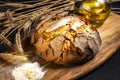 Exposition of fresh home made bread on wooden table, tasty breakfast. Bread with olive oil. Royalty Free Stock Photo