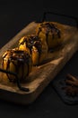 Exposition of fresh organic, baked apple with chocolate and cottage cheese on black background, very tasty desert.