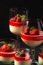 Exposition of fresh organic curd cream and jelly with strawberry on black background.