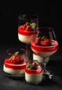 Exposition of fresh organic curd cream and jelly with strawberry on black background. Royalty Free Stock Photo