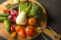 Exposition of fresh organic vegetables on wooden plate. tomato, pepper, broccoli, onion, garlic, cucumber, eggplant, black Eyed P