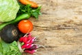 Exposition of fresh organic vegetables on woodetable. Tomatoes, cabbage, radish, cucumber, parsley, black radish, carrot