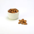 Exposition of porcelain bowl with nuts, pelled almonds, pistachios nuts and walnuts on white background.