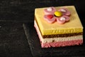Exposition of very taste and colorful marshmallow cake on rock table and black background, very tasty cheesecake.