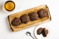 Exposition of very tasty chocolate cake with soft inside in wooden plate on white background,perfect desert with tea.