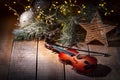 Exposition of violin and background with Christmas tree with light, very beautiful composition, the best day in the year. Royalty Free Stock Photo