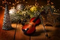 Exposition of violin and background with Christmas tree with light, very beautiful composition, the best day in the year. Royalty Free Stock Photo