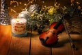 Exposition of violin and background with Christmas tree with light, very beautiful composition, the best day in the year. Royalty Free Stock Photo