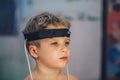 Express biofeedback microcurrent rezonans health of organs diagnostic. Sick child boy wear bioresonance head electrodes Royalty Free Stock Photo