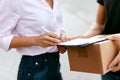 Express Delivery. Courier Delivering Package To Woman Royalty Free Stock Photo