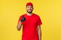 Express mail delivery, package transfer and logistics concept. Young happy, pleased bearded courier in company uniform Royalty Free Stock Photo