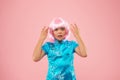 Express negative emotion. kid in traditional Chinese gown. Unhappy small chinese girl in pink wig. Portrait of a Royalty Free Stock Photo