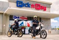 Express Service home delivery bikes with African riders outside local Pick n Pay grocery store