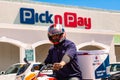 Express Service home delivery man with bike outside local Pick n Pay grocery store