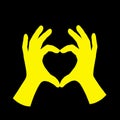 Yellow Hands Making Heart Shape on Black Background: Symbol of Love And Affection Royalty Free Stock Photo