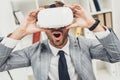 expressed young businessman in vr headset sitting