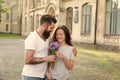 Expressing feelings. Woman enjoy fragrance bouquet flowers. Lady likes flower husband gifted her. couple in love. Man Royalty Free Stock Photo