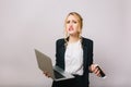 Expressing upset true emotions of blonde businesswoman on white background. Modern office worker, laptop, phone Royalty Free Stock Photo