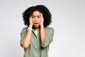 With an expression of concern, this African-American woman holds her head in her hands Royalty Free Stock Photo